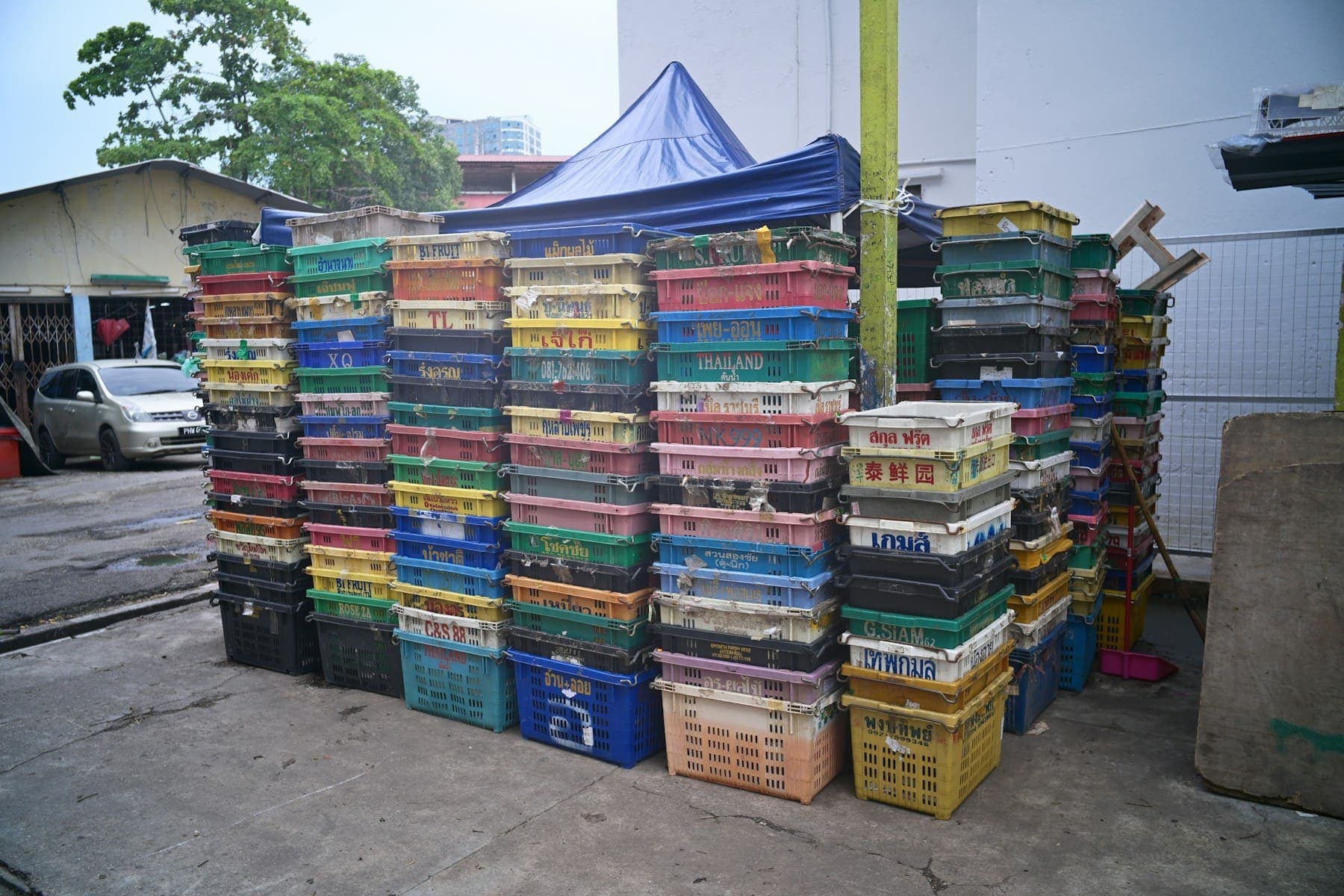 Stacks of colourful produce crates at an aggregation point