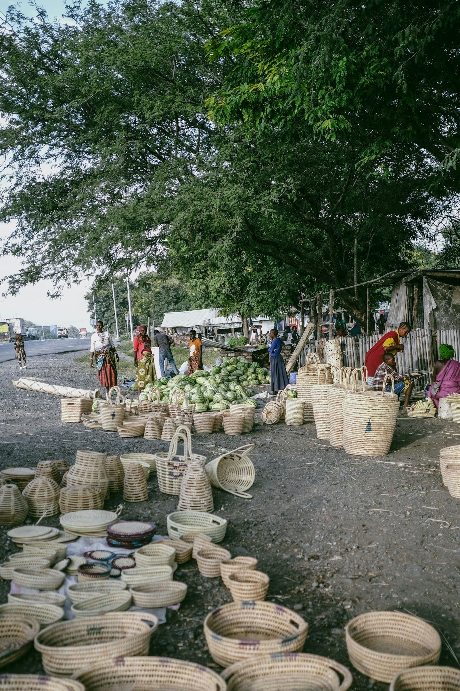 A roadside produce market with woven baskets